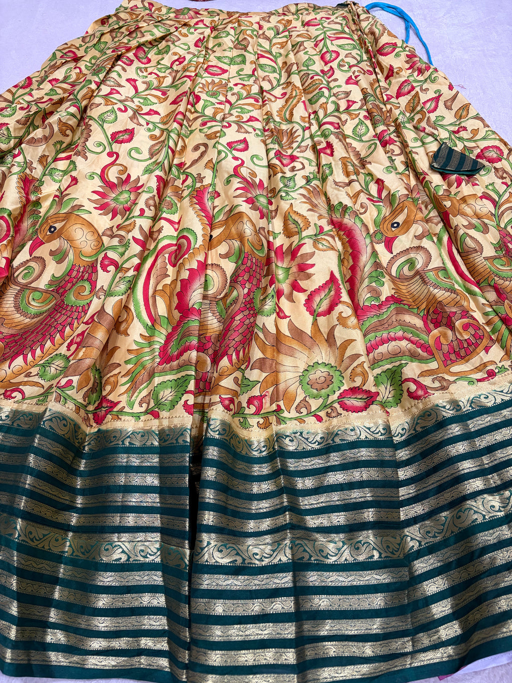 Cream Kalamkari lehenga skirt with bottle green zari border
