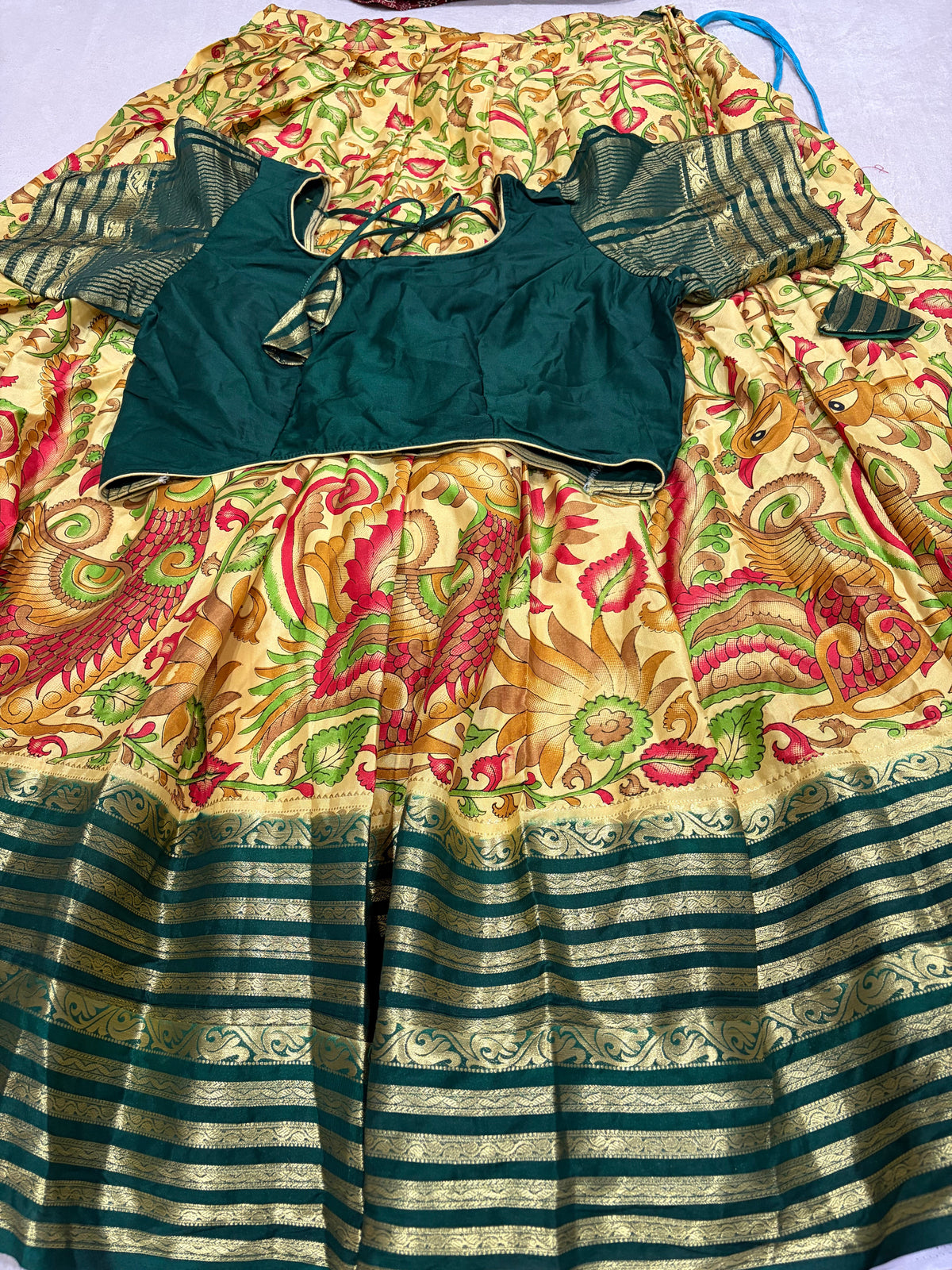 Cream Kalamkari lehenga set with bottle green blouse