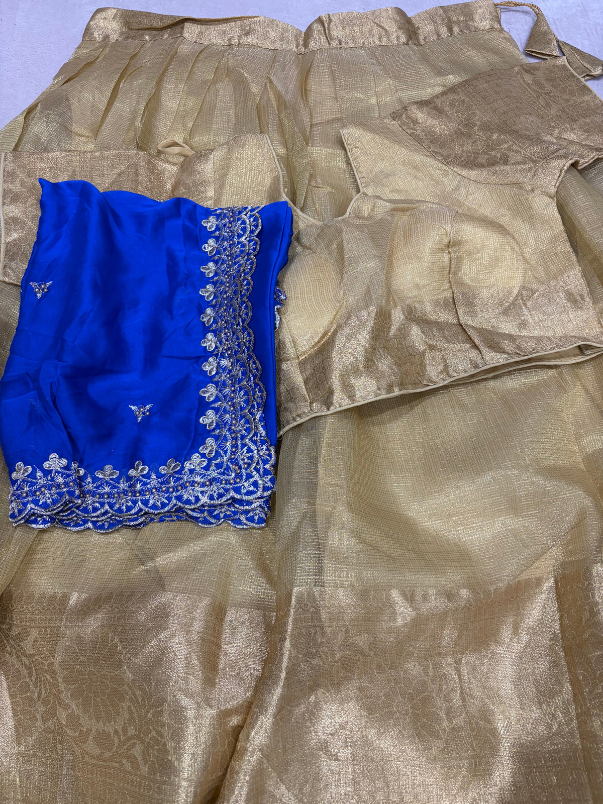 Golden tissue lehenga set with royal blue embroidered dupatta