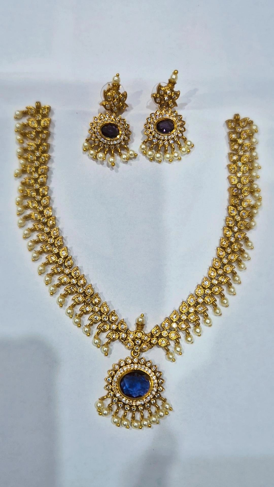 Blue sapphire antique gold kundan pearl drop necklace set with matching chandelier earrings