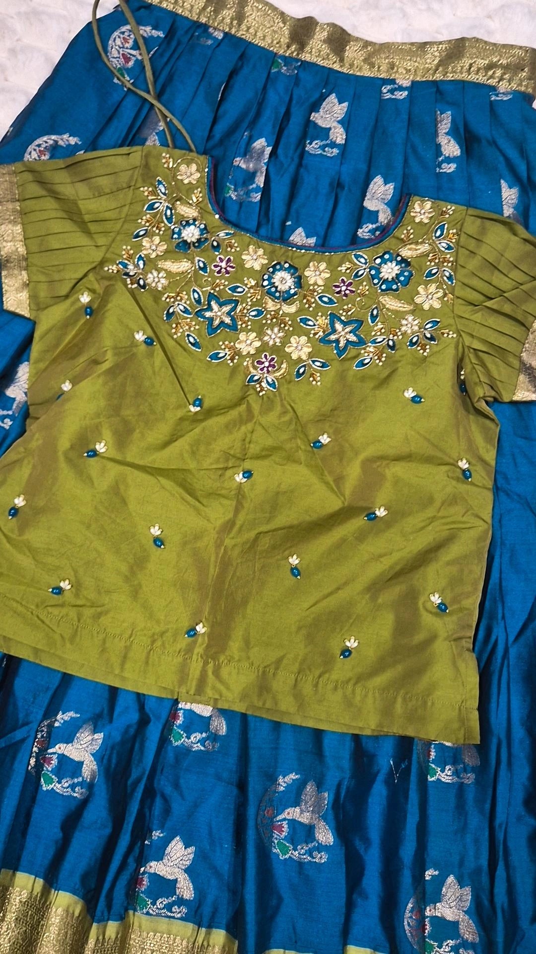 Olive green embroidered blouse with teal pattu pavada skirt