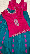 Hot pink embroidered blouse with silver peacock motif and teal Mangalagiri pattu pavada skirt