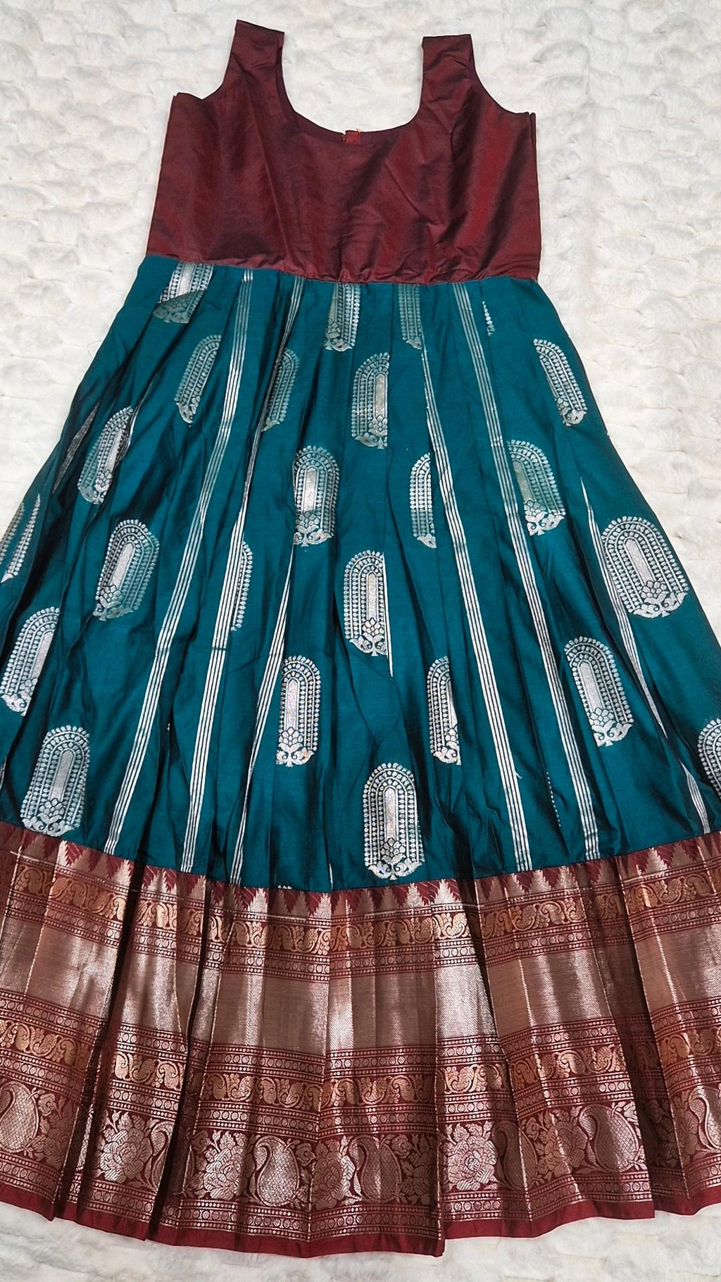 Kids pattu pavada teal silk skirt with silver brocade motifs and maroon gold zari border