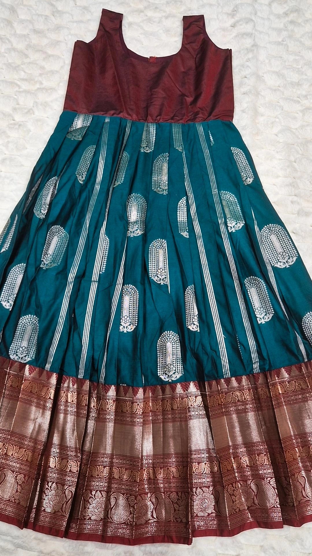 Kids pattu pavada teal silk skirt with silver brocade motifs and maroon gold zari border