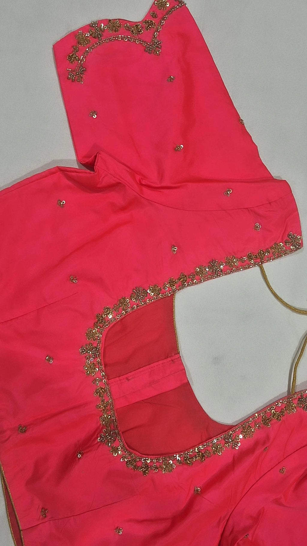 Coral pink sequin floral saree blouse - back view showing round opening