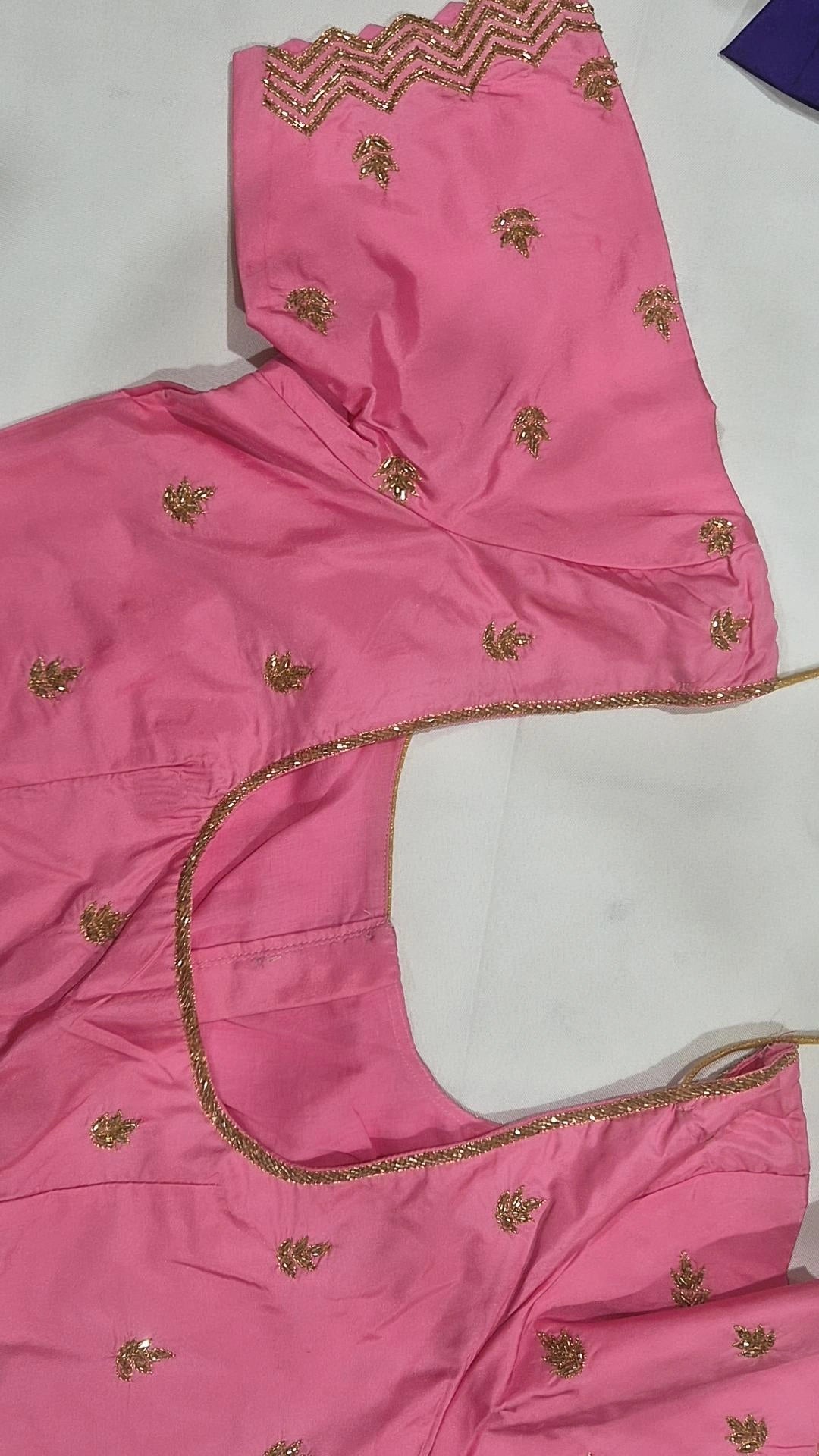 Baby pink saree blouse - back view showing round opening and gold piping