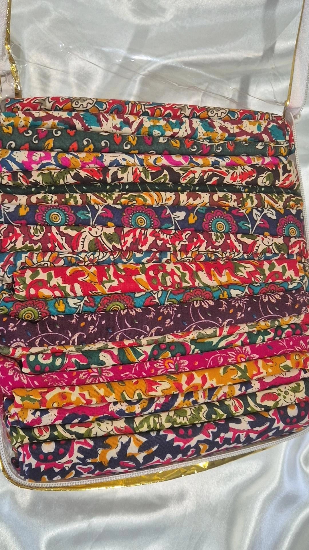 Stack of colourful Indian block print blouse pieces in various floral patterns