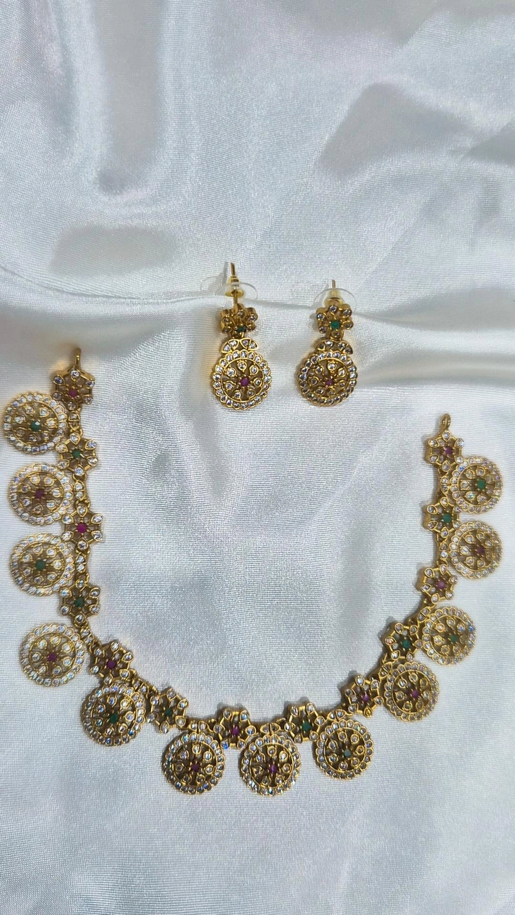 Gold-tone round floral-motif necklace with matching drop earrings and colourful stones