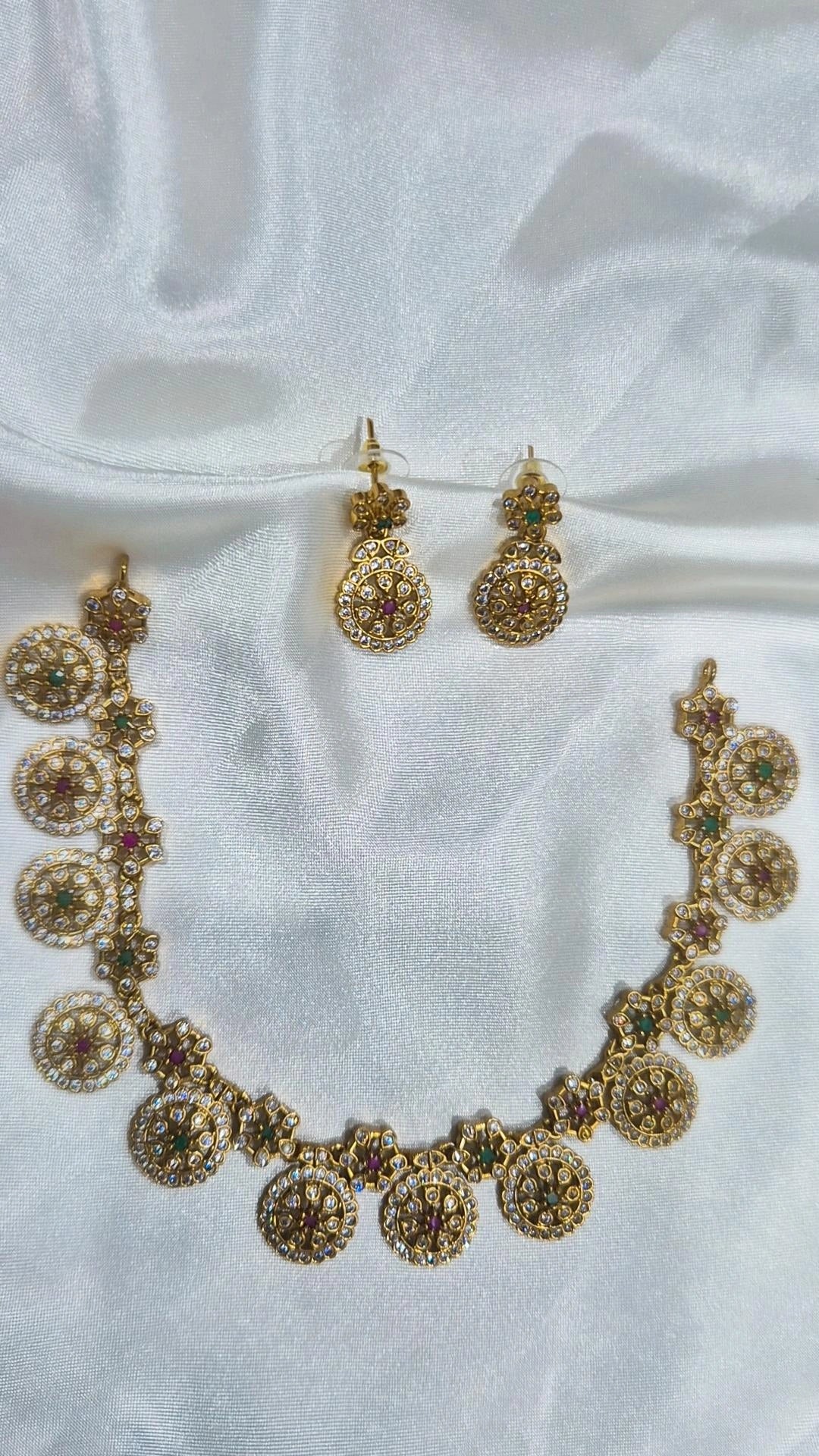 Gold-tone round floral-motif necklace with matching drop earrings and colourful stones