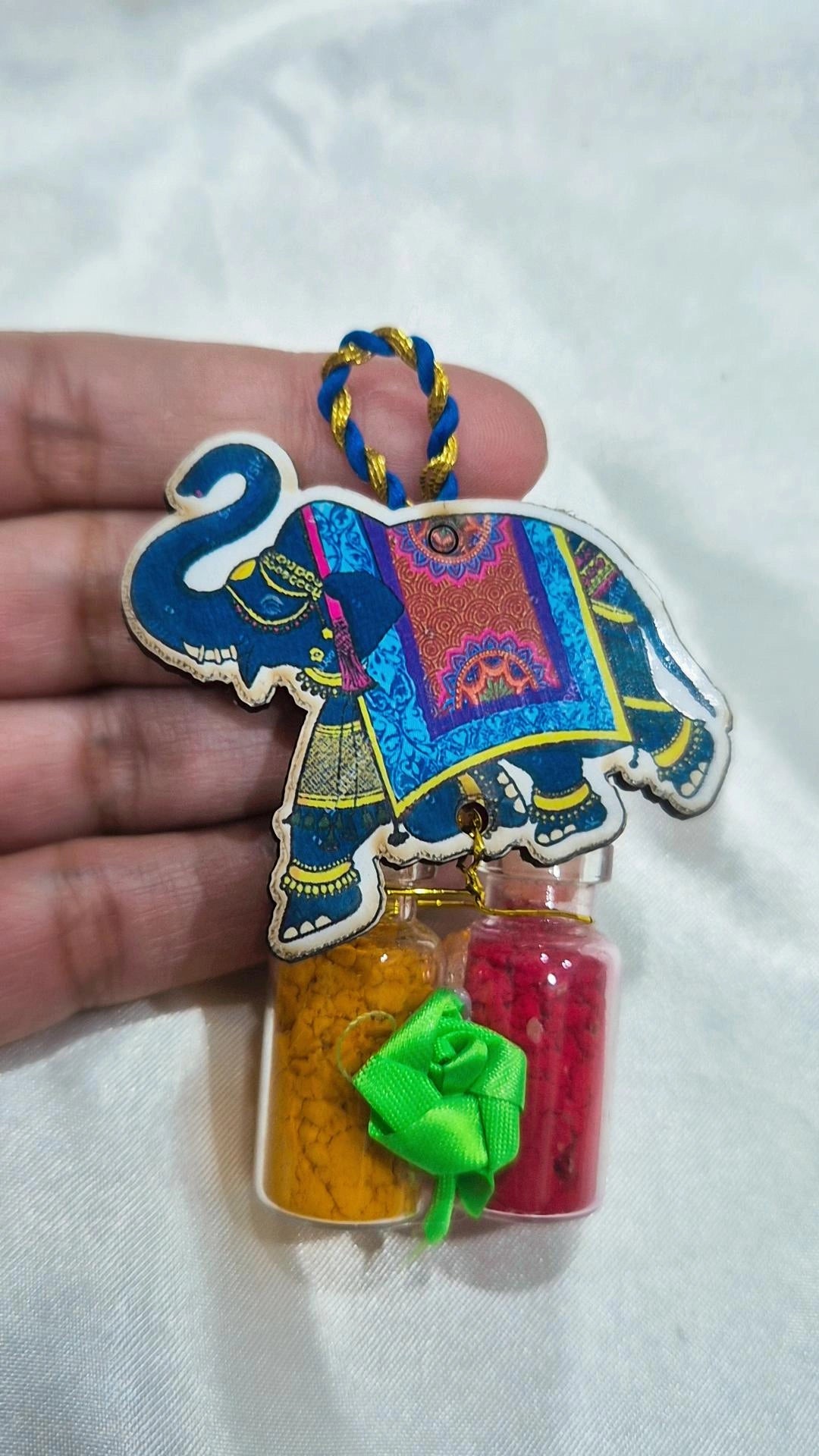 Wooden elephant favor with haldi and kumkum mini bottles and ribbon