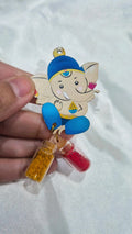 Wooden baby Ganesha favor with haldi and kumkum mini bottles