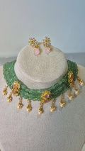Emerald green bead choker necklace set with pearl drops and matching earrings on jewellery stand