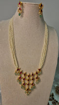Jadau Kundan ruby emerald multi-strand pearl long necklace set with waterfall pendant and matching earrings on jewellery bust