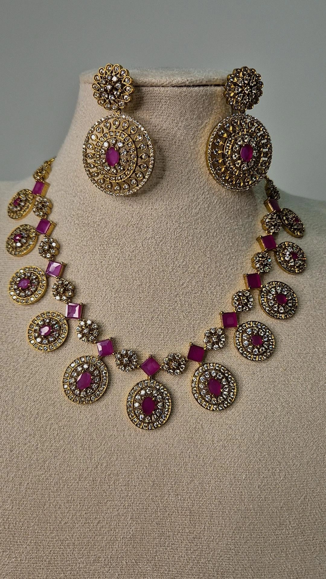 Victorian ruby Bottu Mala necklace set with CZ pavé oval medallions and matching drop earrings on jewellery bust