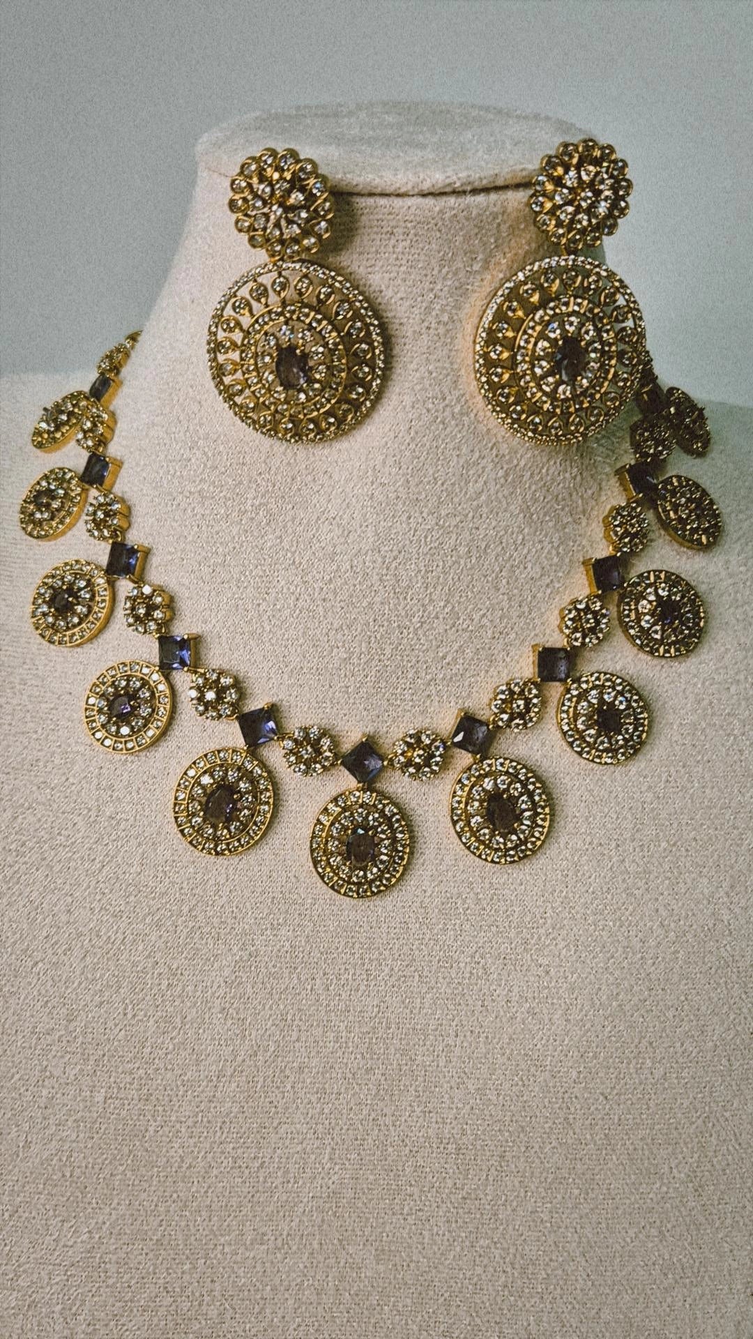 Victorian gold CZ Bottu Mala necklace set with sapphire blue links and matching circular drop earrings on jewellery bust