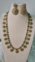 Victorian gold CZ emerald long Bottu Mala necklace set with emerald green links and matching circular drop earrings on jewellery bust