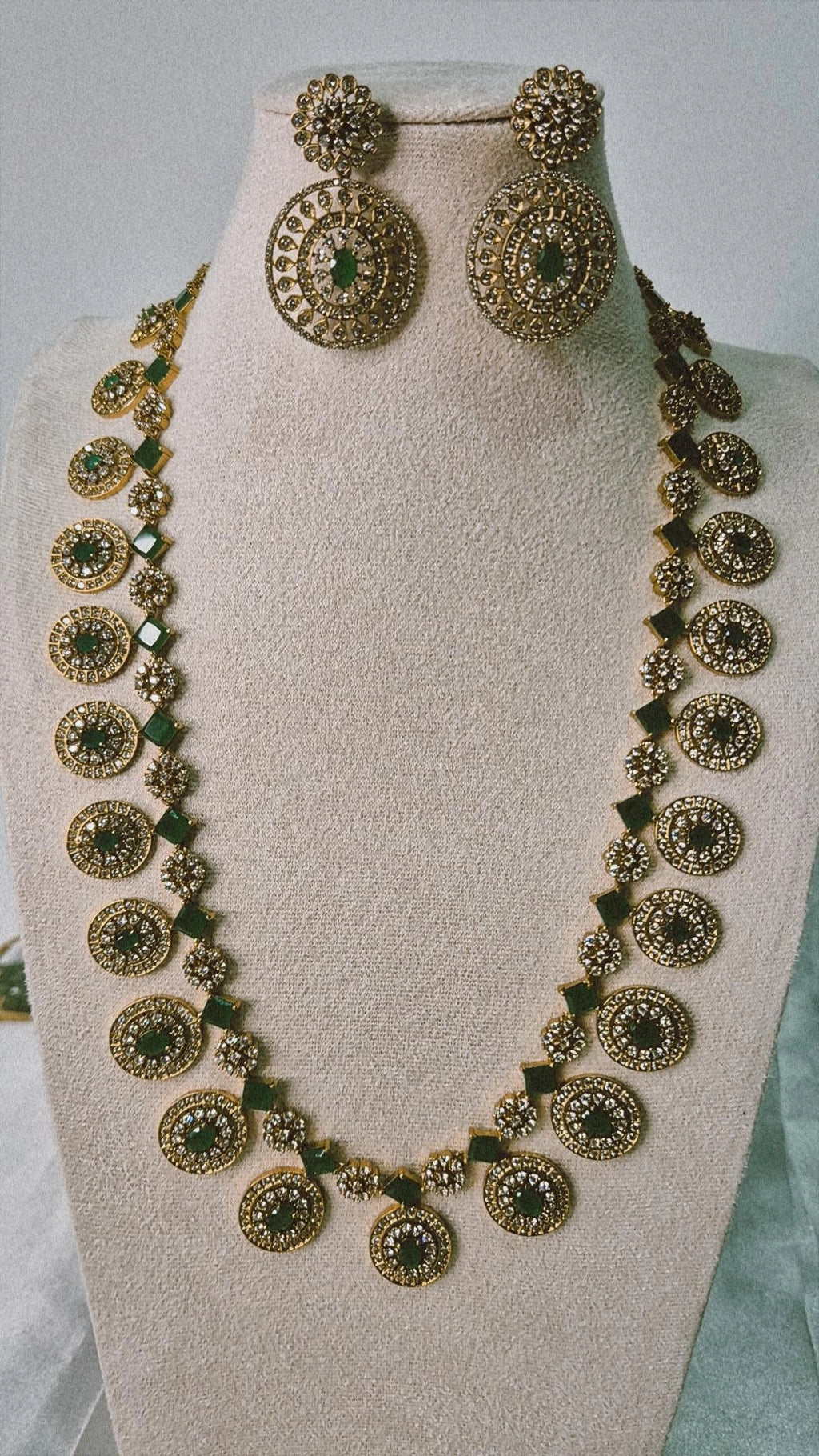 Victorian antique gold CZ long Bottu Mala necklace with emerald oval stones and square links displayed on jewellery bust with earrings