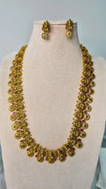 Lakshmi temple antique gold long haram necklace with ruby and emerald accents and matching ball drop earrings on jewellery bust