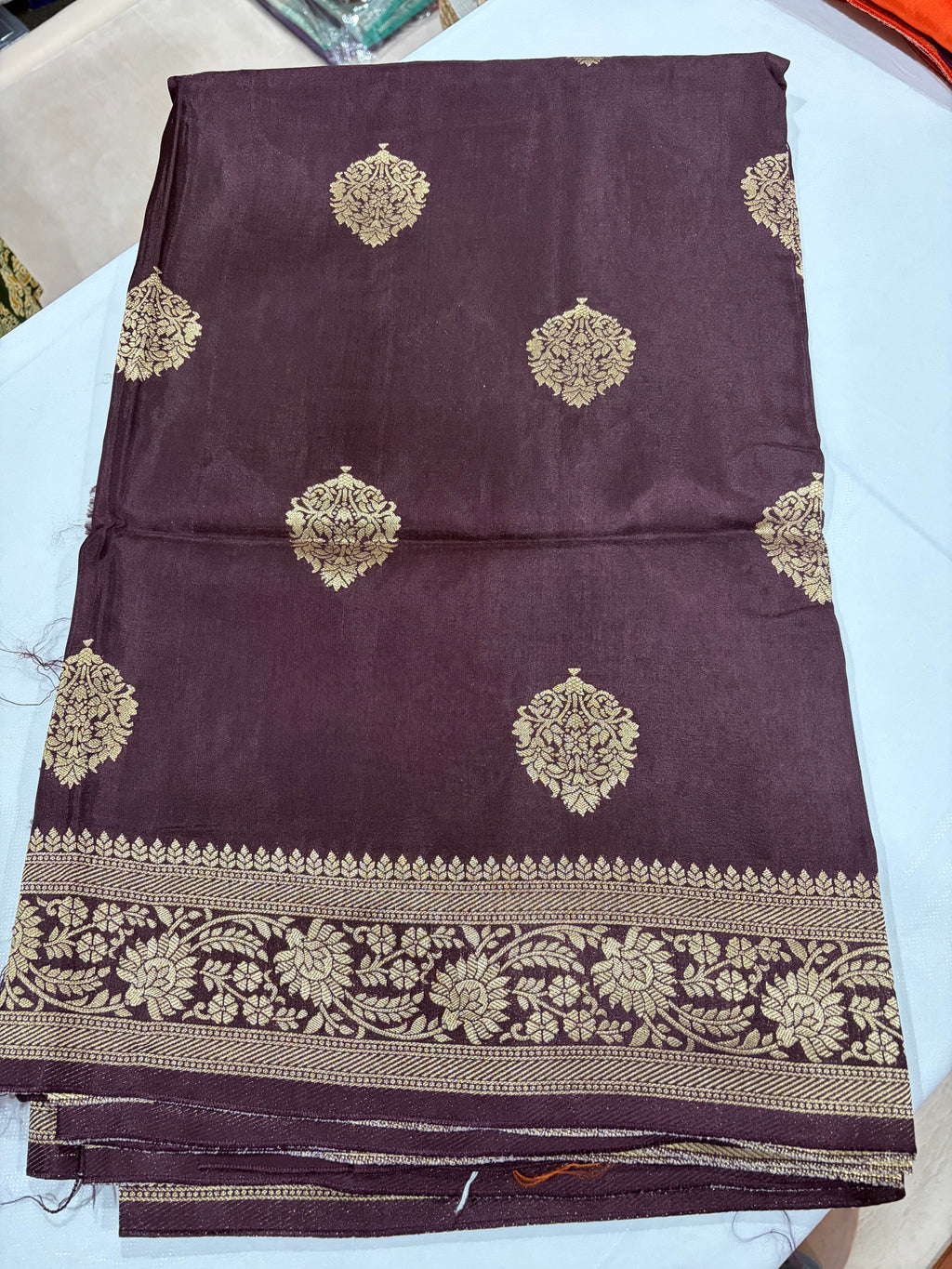 Dark Wine Crape Banarasi Saree - Folded full view with gold zari buttas