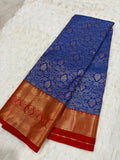 Royal blue Kanjivaram silk saree folded showing all-over silver zari jaal and red gold border