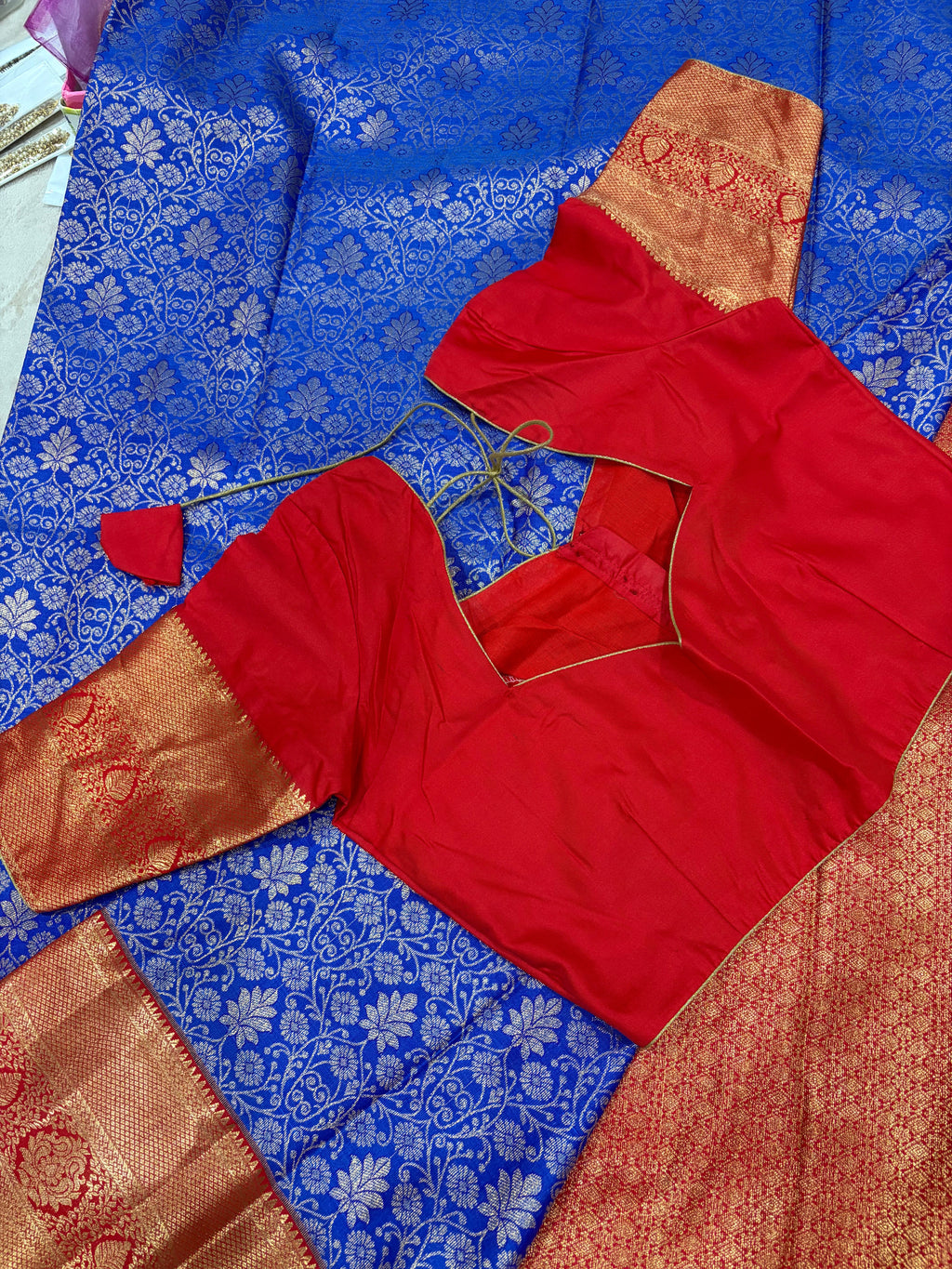 Close up of royal blue Kanjivaram saree body with silver zari jaal and red gold pallu border