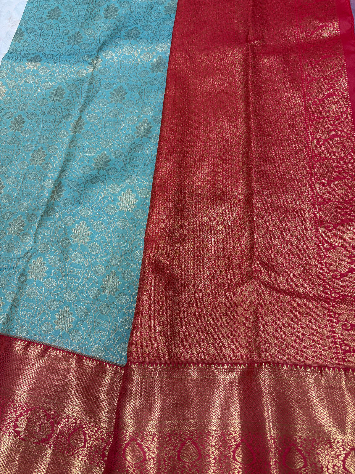 Close up of teal Kanjivaram saree body with gold zari jaal and wide red gold pallu