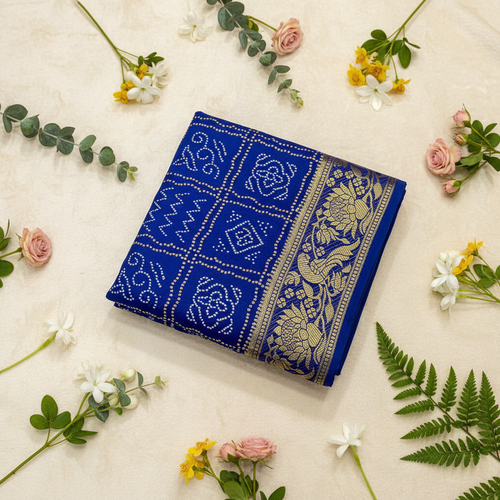 Blue Bandhani Kanjivaram saree on cream background with flowers