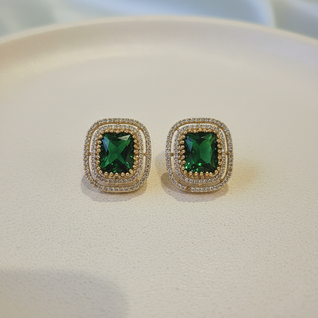 Gold Emerald Green CZ Cushion Studs - cream flat lay