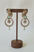 Gold Parrot Hoop Earrings - dark brown stand