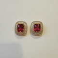 Gold Red Ruby CZ Cushion Studs - cream flat lay